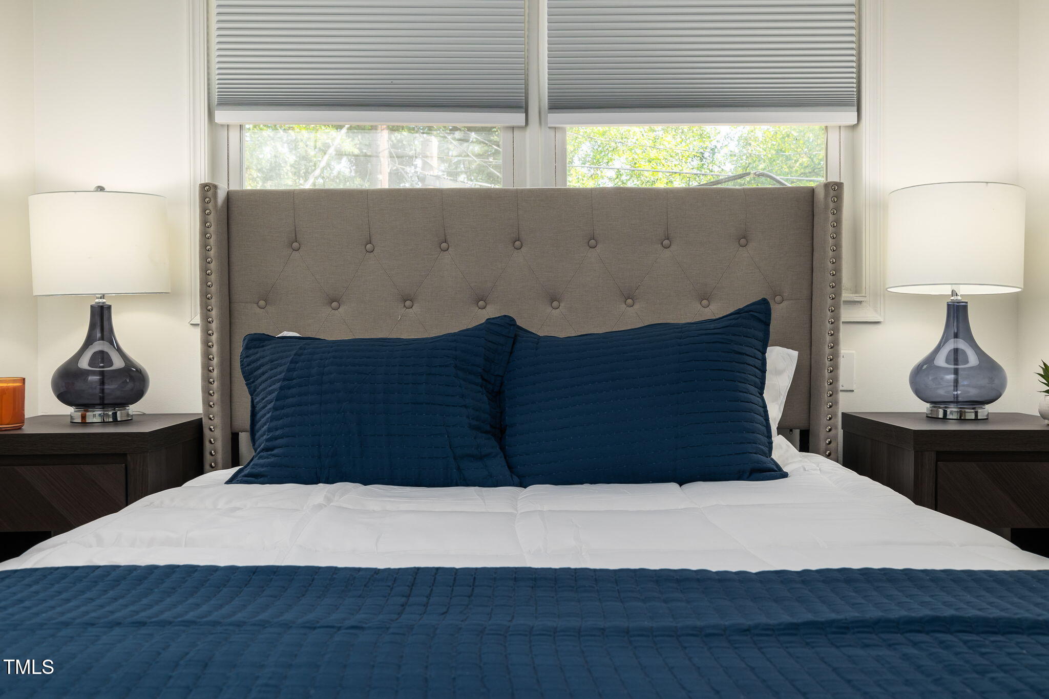 1911 Morehead Avenue Durham, NC 27707 - Photo 23 of 25 a bed sitting in a bedroom next to a window