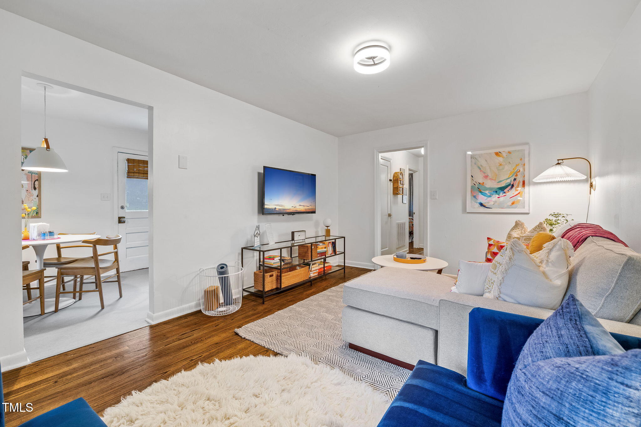 1911 Morehead Avenue Durham, NC 27707 - Photo 5 of 25 a bedroom with furniture and a wooden floor