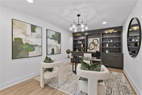 a living room with furniture a chandelier and a rug