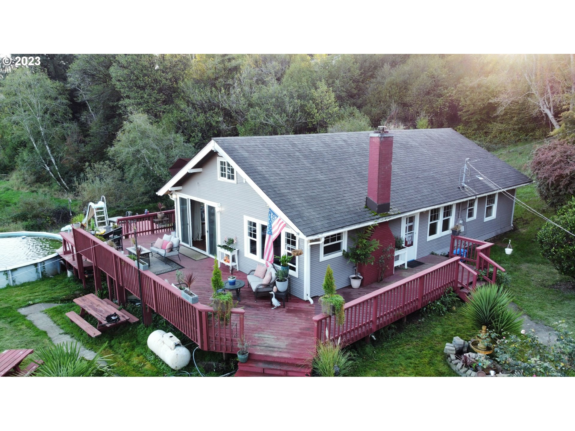 a aerial view of a house with roof deck front of house