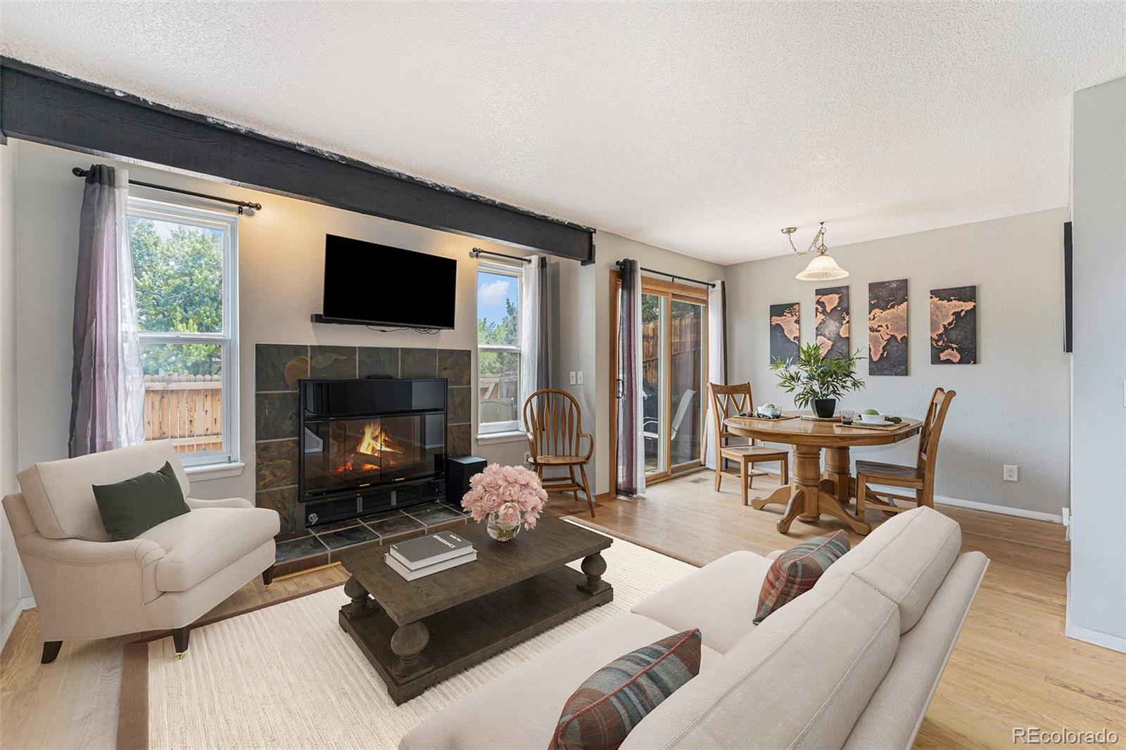 a living room with furniture fireplace and a large window
