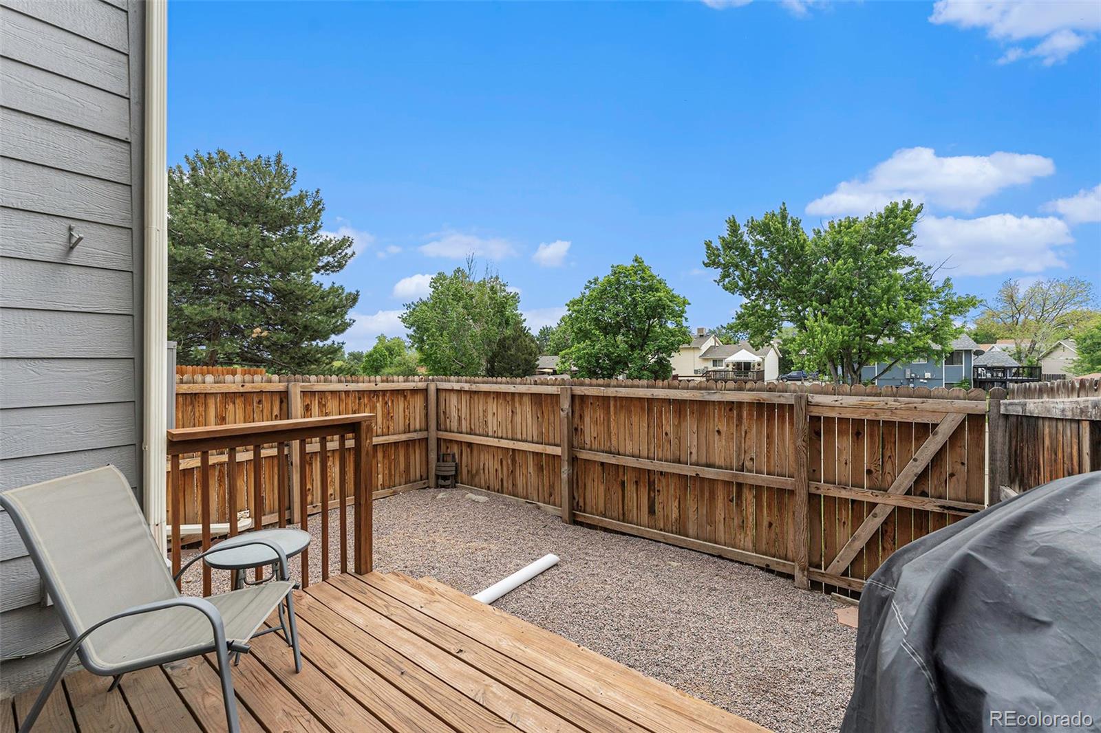 8642 Carr Loop Arvada, CO 80005 - Photo 17 of 22 a view of a balcony with wooden floor and outdoor seating