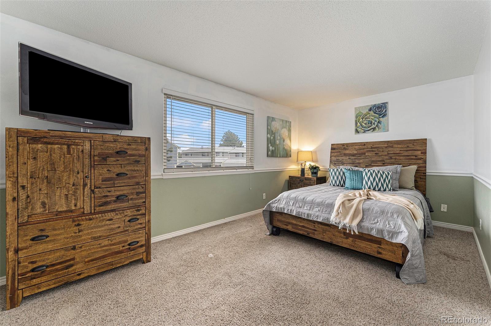 8642 Carr Loop Arvada, CO 80005 - Photo 4 of 22 a bedroom with a bed and furniture