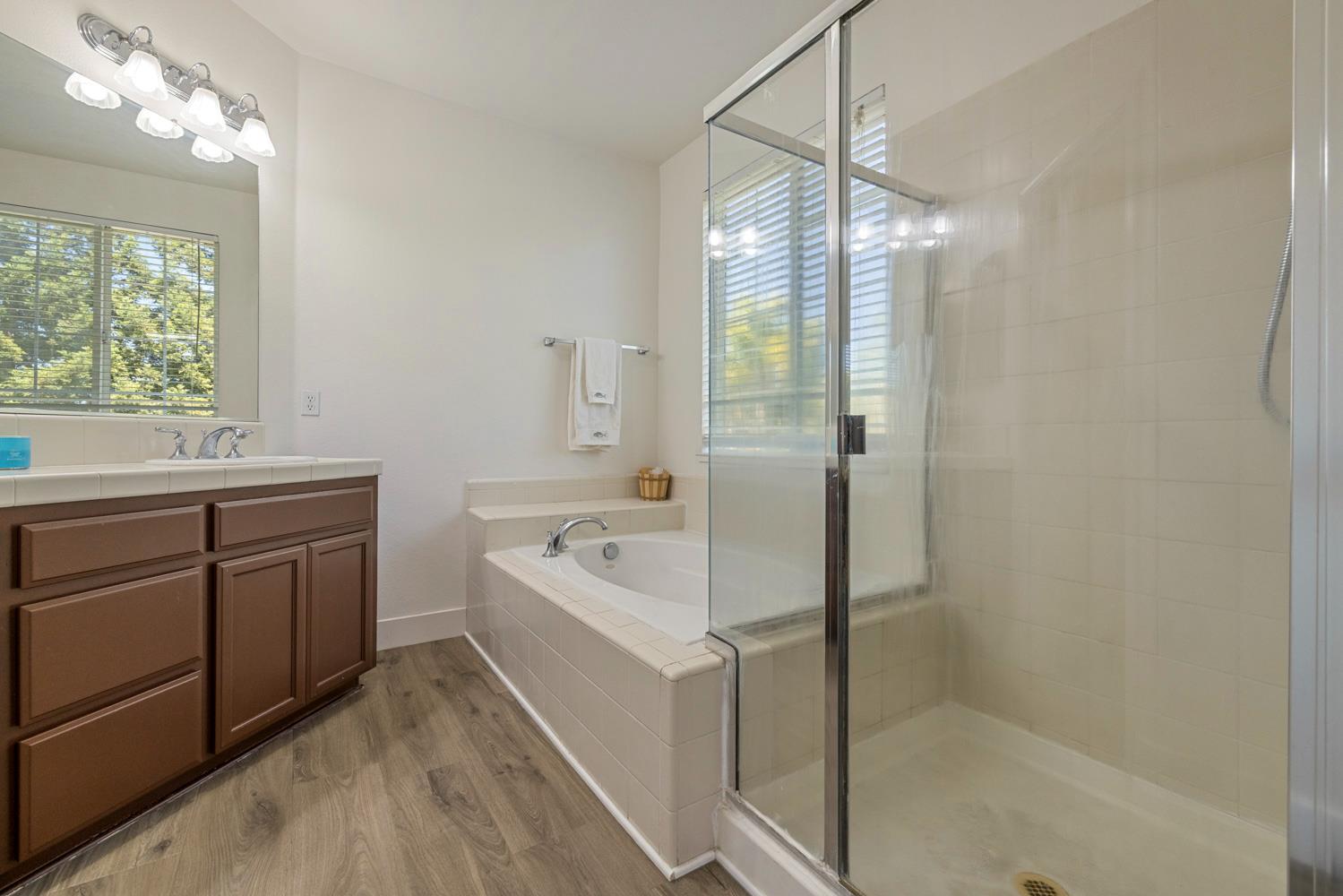 3105 Ripple Court Modesto, CA 95355 - Photo 27 of 46 a bathroom with a tub sink shower and mirror