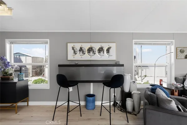 a living room with furniture and a painting on the wall