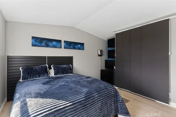a bedroom with a bed and a ceiling fan