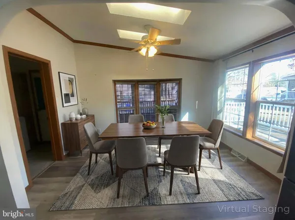 a view of a dining room with furniture a chandelier and wooden floor