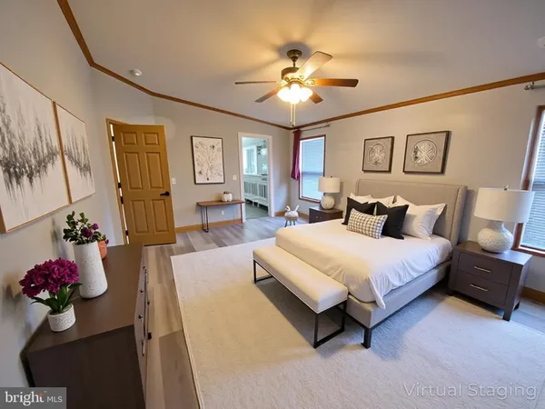 a spacious bedroom with a bed and a chandelier