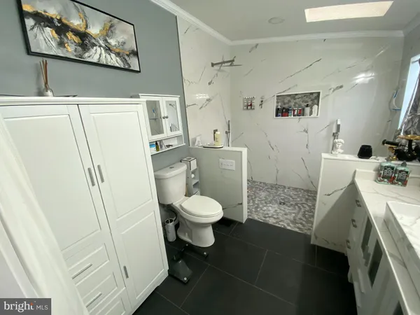 a bathroom with a sink a toilet and a shower