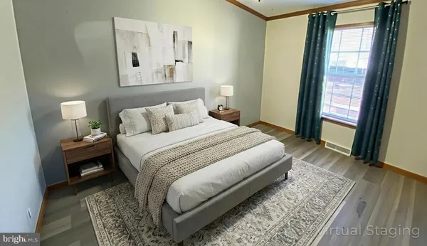 a bedroom with a bed lamp on desk and a window