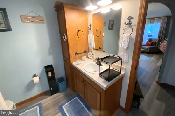a bathroom with mirror and vanity