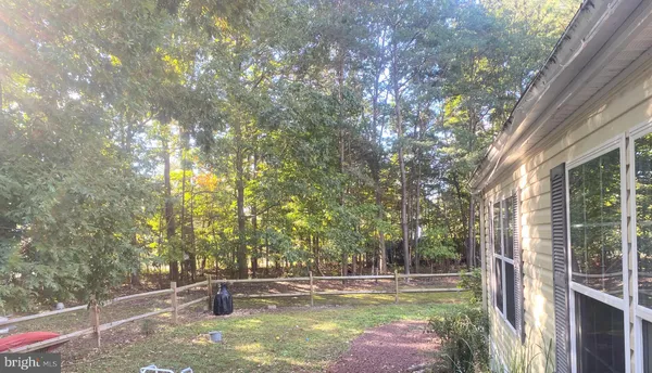 a view of a swimming pool with a patio and a yard