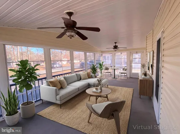 a living room with furniture potted plant floor to ceiling window