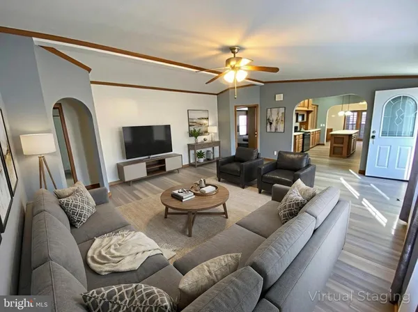 a living room with furniture and a flat screen tv