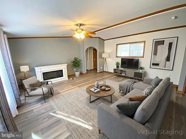 a living room with furniture a fireplace and a flat screen tv