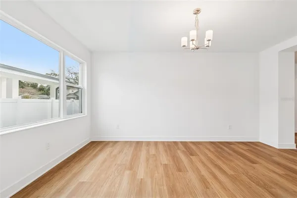a large kitchen with cabinets wooden floor and a sink
