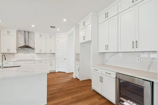 a kitchen with granite countertop cabinets stainless steel appliances and wooden floor