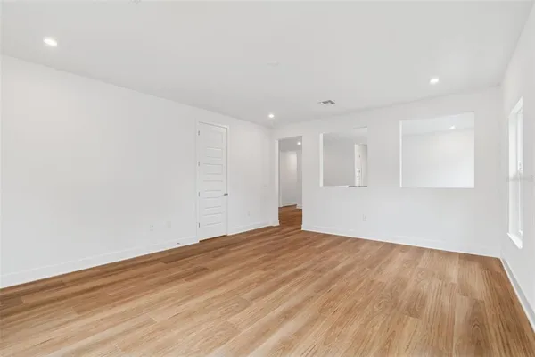 a bathroom with a tub a sink and mirror