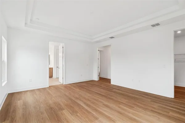 a view of empty room with wooden floor