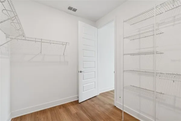 a view of an empty room and wooden floor
