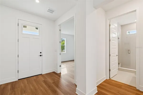 a view of a room with wooden floor and a window