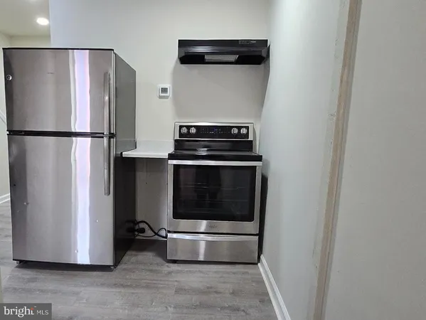 a stove top oven sitting inside of a kitchen