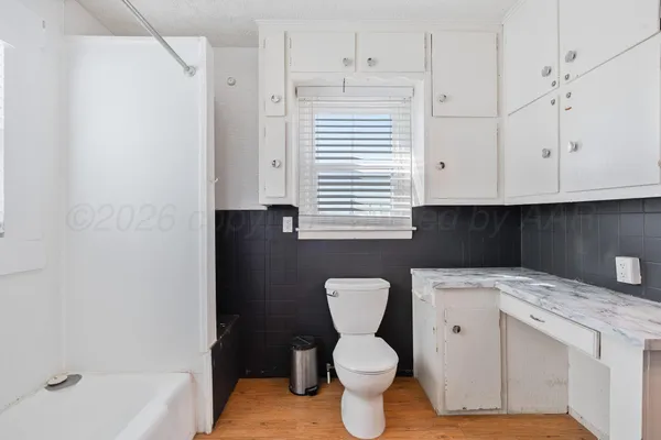 a bathroom with a sink a toilet and bathtub