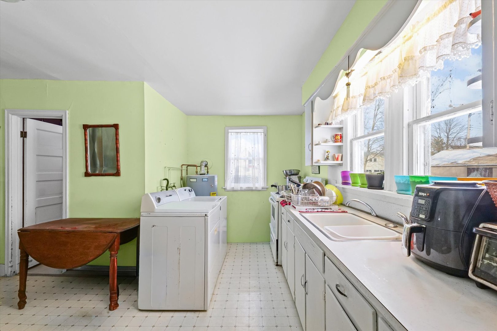 524 North State Street Gibson City, IL 60936 - Photo 11 of 22 a view of a kitchen with kitchen island a sink dishwasher a stove with open dining table and chairs