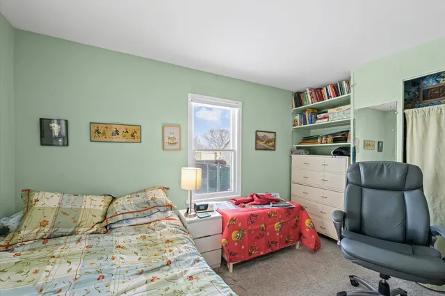 a bedroom with a bed furniture and decor