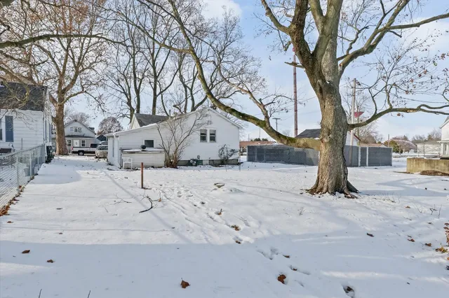 a view of a yard covered with snow on the road