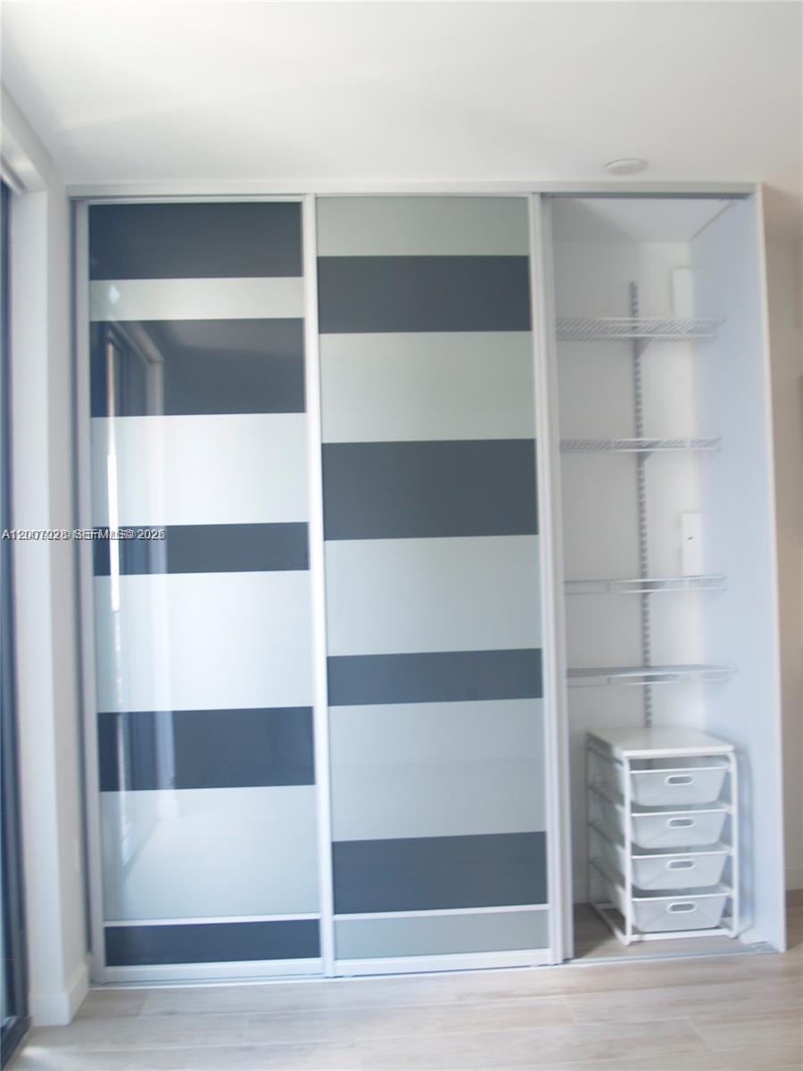 55 Southwest 9th Street, Unit 2502 Miami, FL 33130 - Photo 9 of 27 a view of walk in closet with empty racks