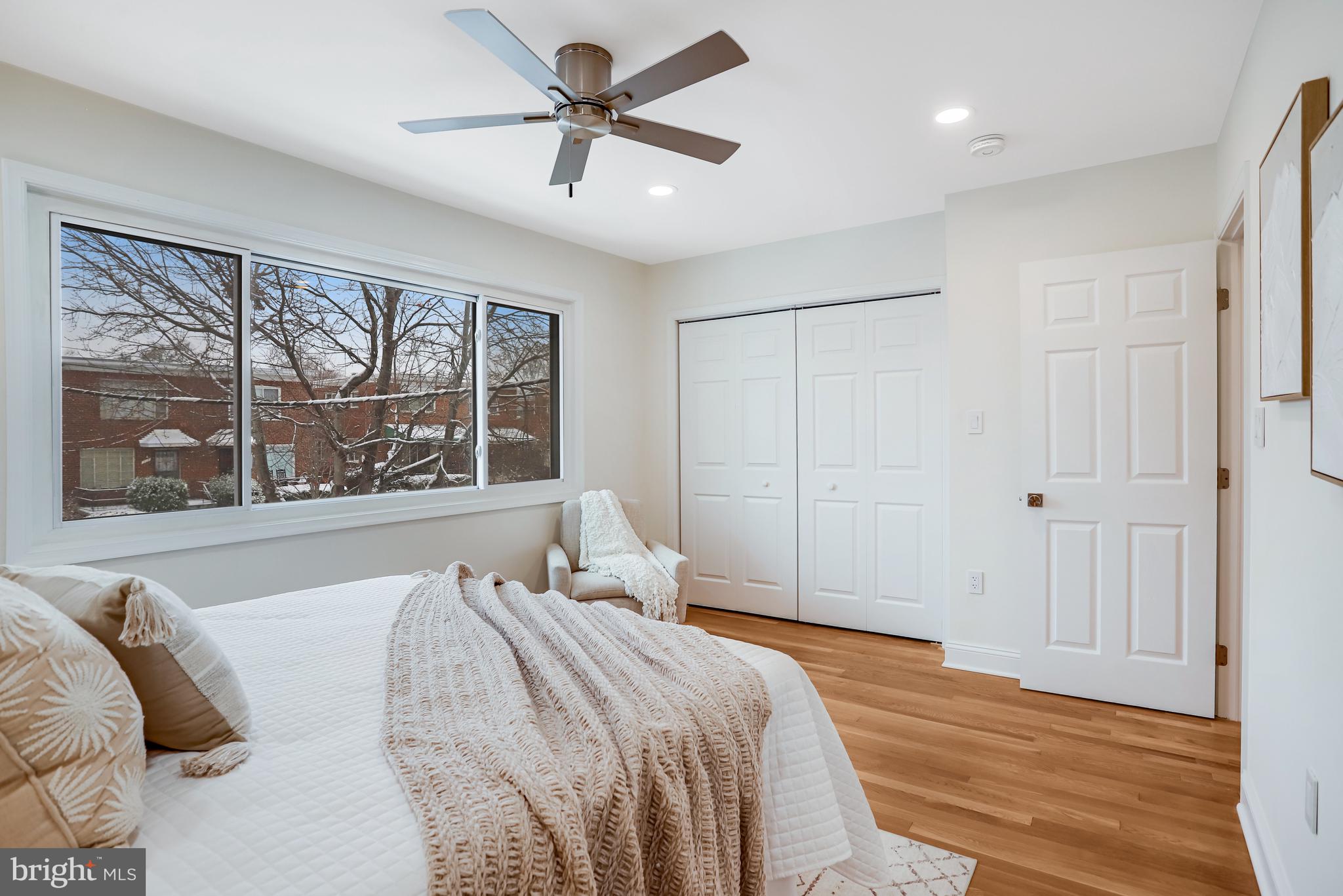 720 Decatur Street Northeast Washington, DC 20017 - Photo 14 of 26 a bedroom with a large bed and a large window