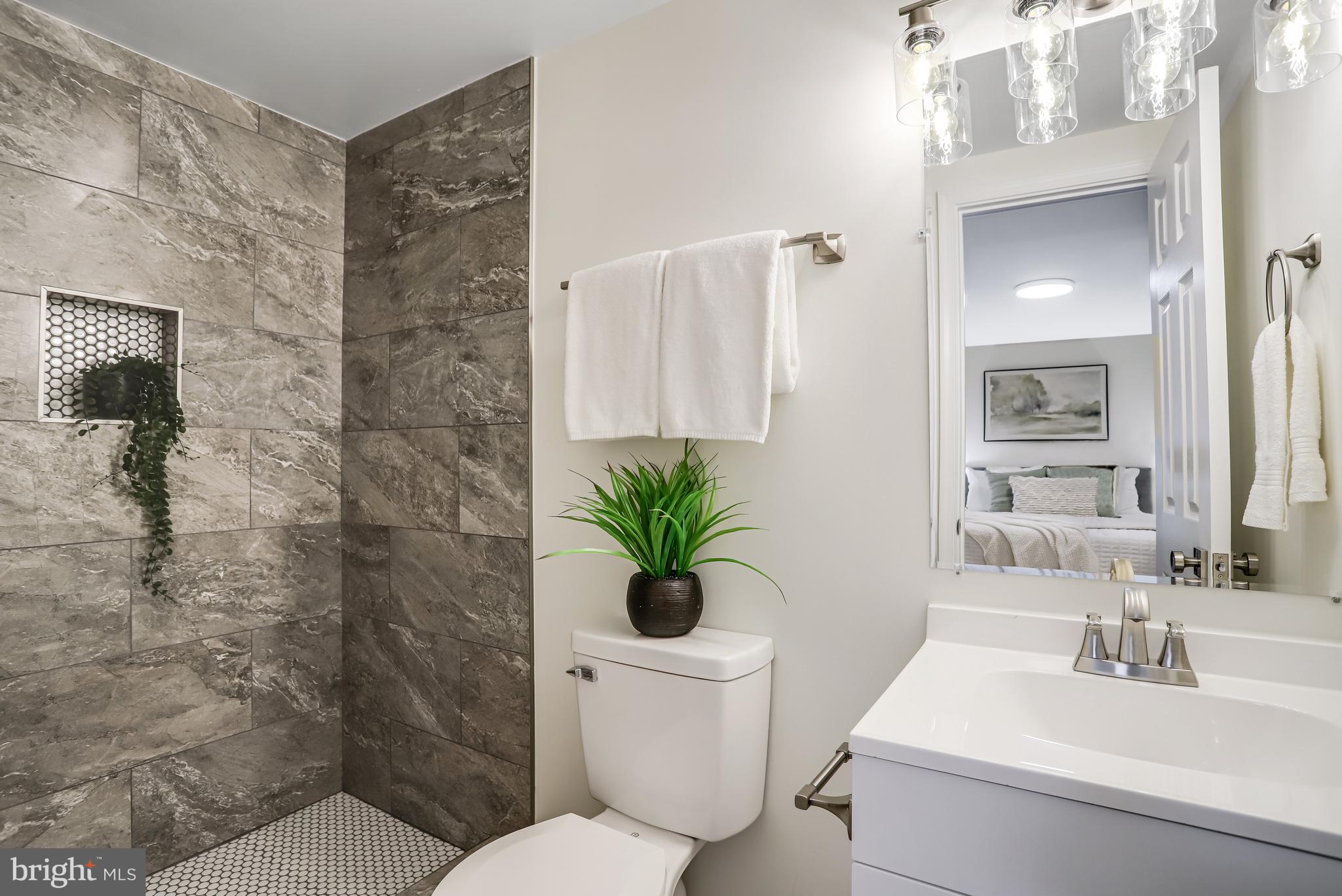 720 Decatur Street Northeast Washington, DC 20017 - Photo 15 of 26 a bathroom with a sink a toilet and a mirror