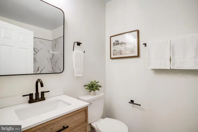 a bathroom with a toilet sink and mirror