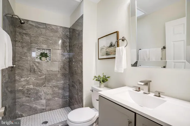 a bathroom with a sink toilet and shower
