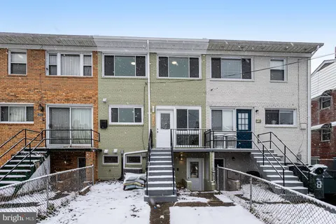 a front view of a house with many windows