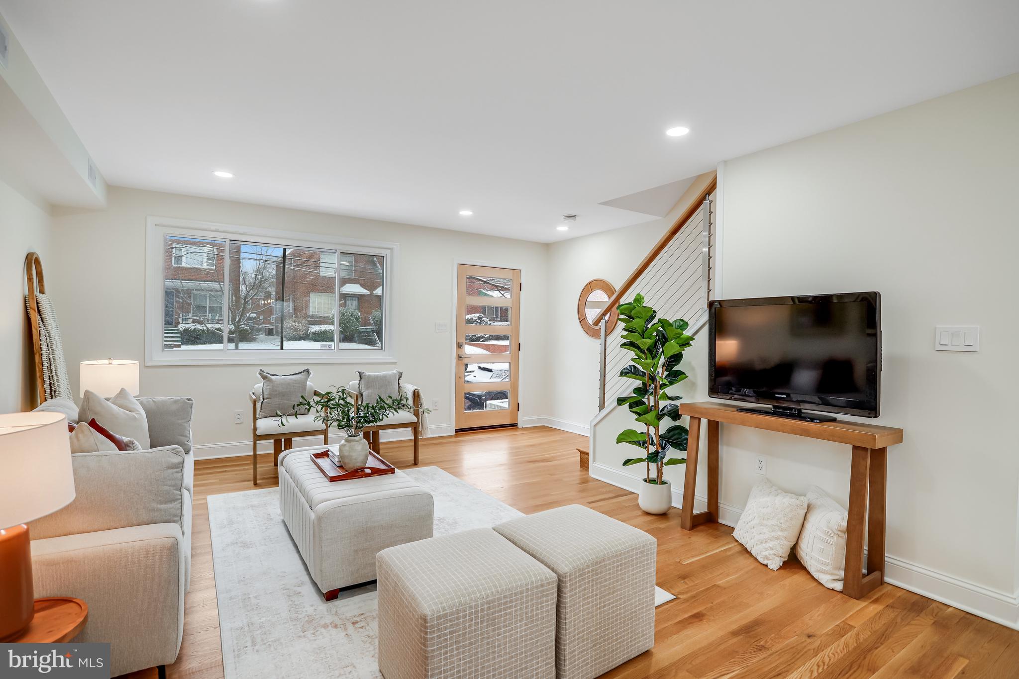 720 Decatur Street Northeast Washington, DC 20017 - Photo 3 of 26 a living room with furniture and a flat screen tv