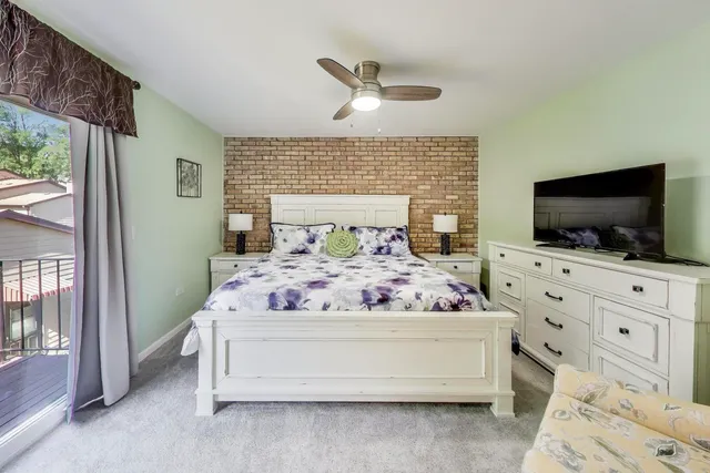 a bedroom with a bed and flat screen tv