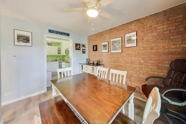 a view of a dining room with furniture and a potted plant