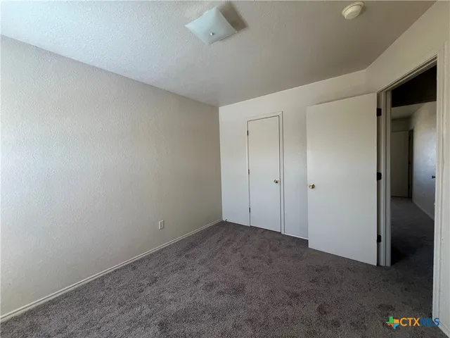 an empty room with a empty space and windows