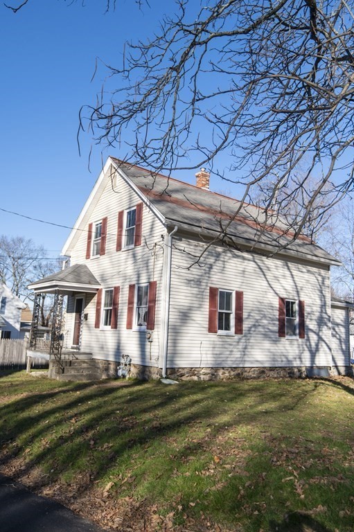 2 Burnside Street Maynard, MA 01754 - Photo 2 of 21 a front view of a house with a yard table and chairs
