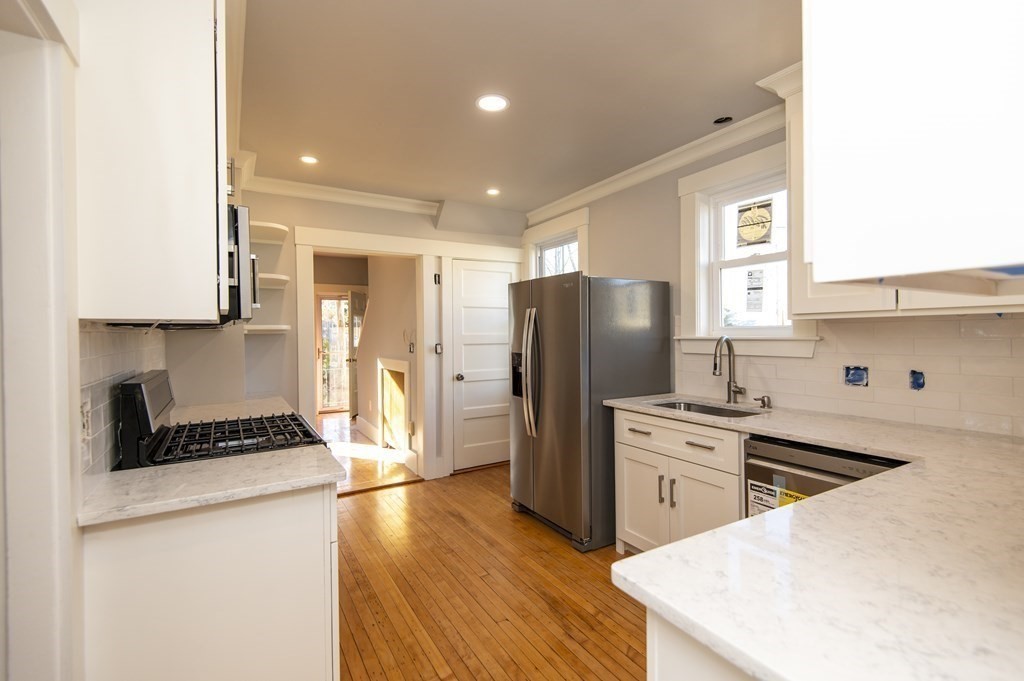 2 Burnside Street Maynard, MA 01754 - Photo 3 of 21 a kitchen with a refrigerator and a stove top oven