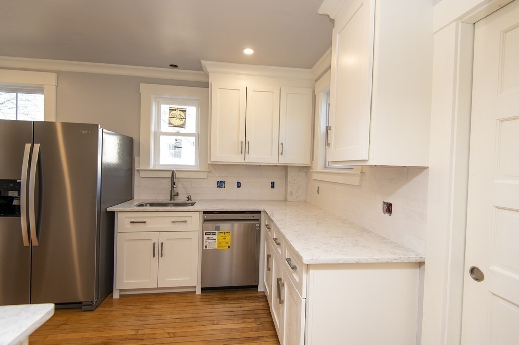 2 Burnside Street Maynard, MA 01754 - Photo 5 of 21 a kitchen with a stove a refrigerator and a sink