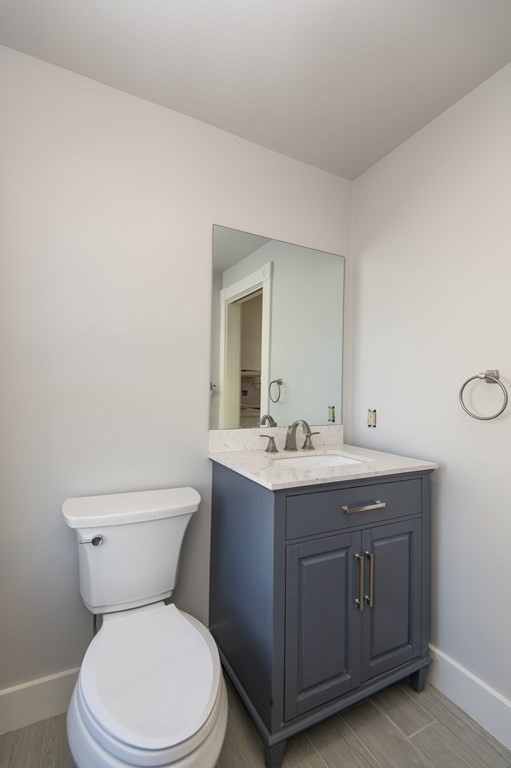 2 Burnside Street Maynard, MA 01754 - Photo 7 of 21 a bathroom with a toilet a sink and mirror