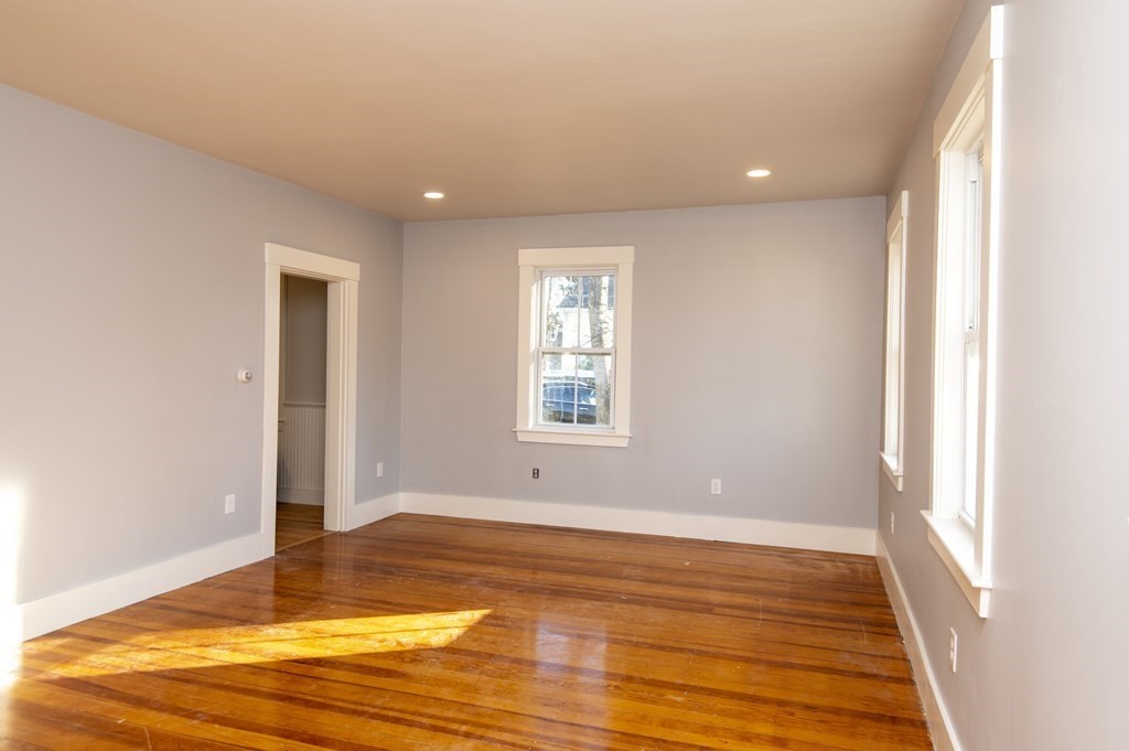 2 Burnside Street Maynard, MA 01754 - Photo 8 of 21 a view of an empty room with window and wooden floor