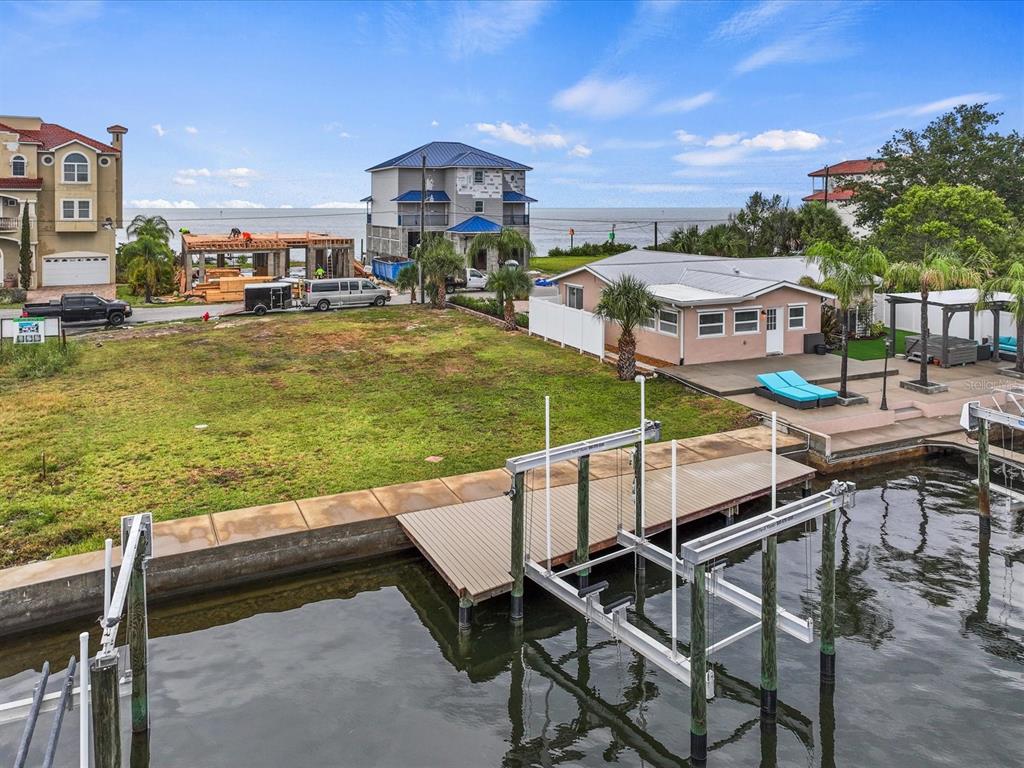 6200 Lonnie Lee Lane Hudson, FL 34667 - Photo 3 of 13 a view of a swimming pool with lawn chairs and a yard