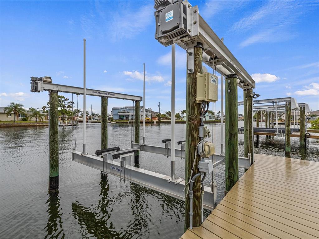 6200 Lonnie Lee Lane Hudson, FL 34667 - Photo 8 of 13 a view of a balcony with dining table and chairs with wooden floor