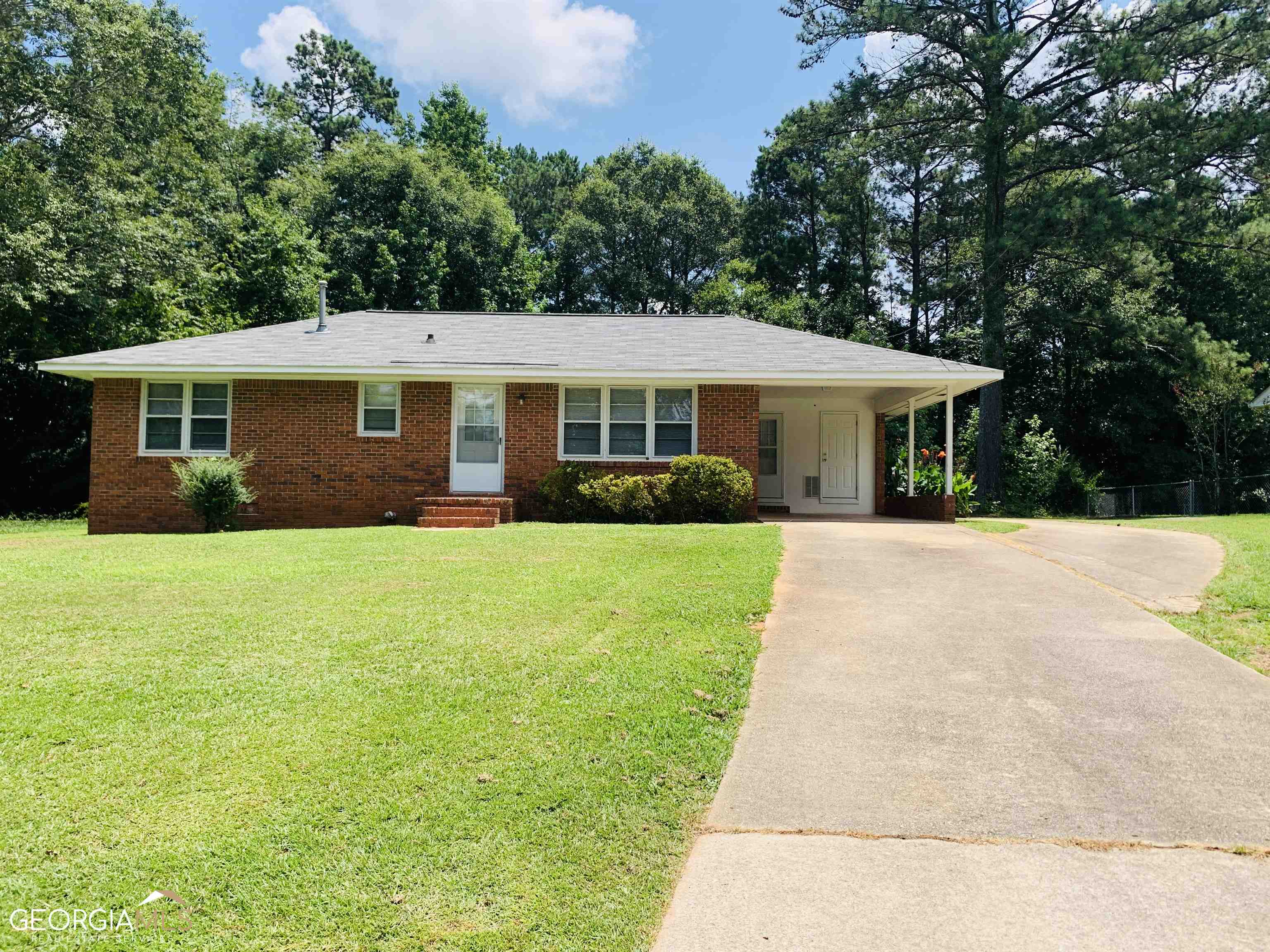 a view of house that has a yard