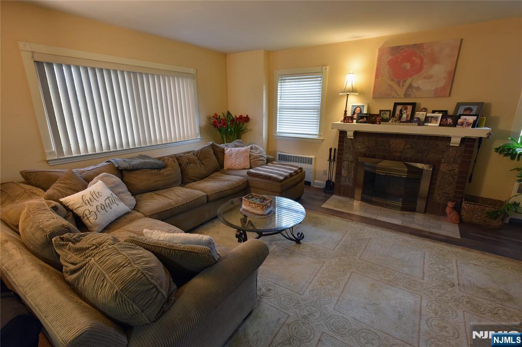 585 Monroe Place Ridgefield, NJ 07657 - Photo 6 of 28 a living room with furniture and a fireplace