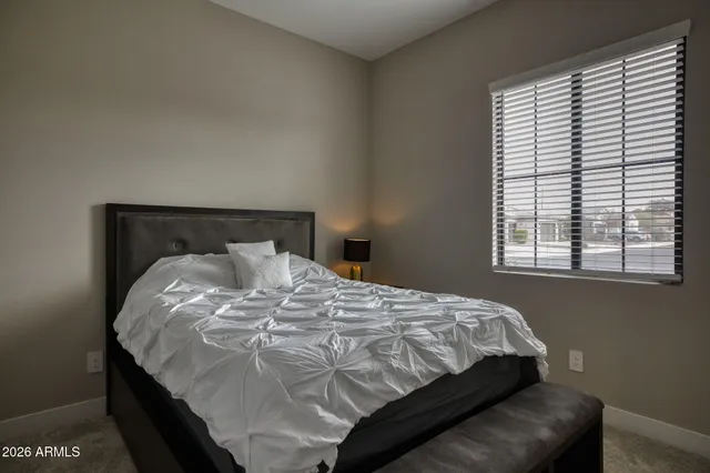 a bedroom with a bed and window
